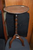A traditional oak pedestal wine table, diameter approx 30cm, some repair and warping