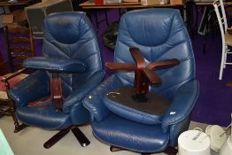 A pair of stressless style armchairs and footstools in dark blue