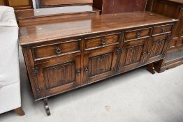 An oak side board having four drawers in a traditional design measuring 188cm long 50deep and 87cm