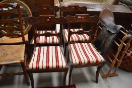 A set of four reproduction mahogany rail back dining chairs