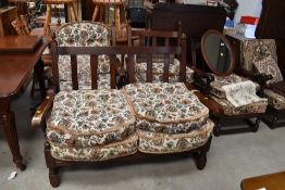 A lounge set comprising of two seat sofa and two arm chairs in solid oak with a priory style
