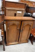 An Old Charm styled door fronted book case measuring 80cm wide 90cm tall and 25cm deep