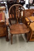 An oak carver dining chair with stick back and medium stain