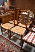 A set of four traditional oak rush seated ladder back chairs