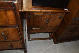 A small side table or cabinet unit in a priory style stained oak