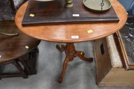 A Victorian satinwood occasional table having oval top on turned column and triple splay base, width