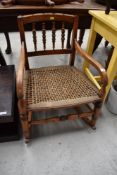 A 19th Century spindle back rocking chair having strung seat and turned frame