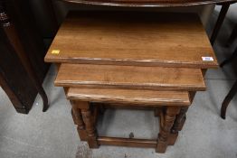 A nice quality solid golden oak nest of three tables