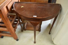 A demi lune hall side table with mahogany veneer