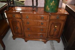 A reproduction yew wood, breakfront sideboard of small proportions, width approx. 104cm