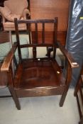 A traditional stained frame commode chair