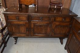 A small long board cupboard in stained oak having three drawers