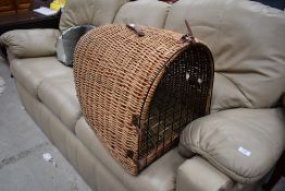 A traditional dome style wicker pet basket, large size, length approx. 60cm, leather strap broken