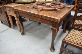A traditional oak drawer leaf table , on Queen Anne style legs