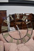 An oversized metal frame wall clock, diameter approx. 122cm