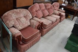 A modern pink dralon and floral three piece lounge suite