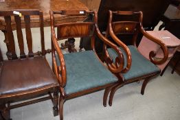 A pair of reproduction scroll carver chairs