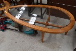A vintage teak teardrop coffee table
