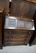 An oak stained writing desk or bureau having four drawers