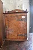 A small oak cupboard possibly a smokers cabinet