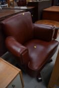 A vintage leather swivel chair, suitable for office or living space, in fashionable brown leather on