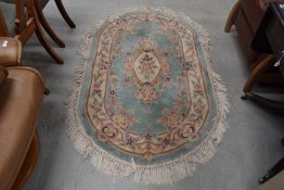 A vintage oval rug, by St Michael, Green Mandarin pattern, approx 152 x 91cm
