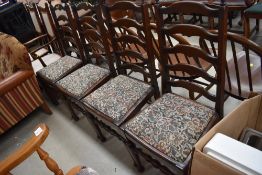 A set of 4 mid century dark stained ladder back dining chairs