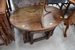 A traditional solid oak oval nest of tables, width of largest table approx. 80cm