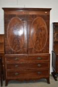 An Edwardian mahogany and satinwood banded linen press, wardobe upper section over three long drawer