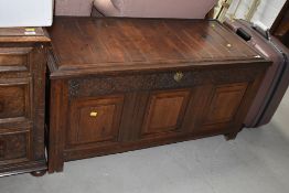 A composite part reproduction oak panelled kist, carved panel frieze dated 1708