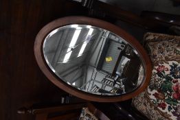 A bevel edged mahogany framed mirror with band detailing