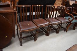A set of four mid 20th Century oak rail back dining chairs