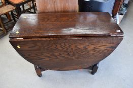 A modern drop leaf dining table with a dark oak stain