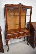 A modern continental style display cabinet on cabriole legs
