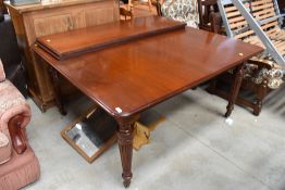 A Victorian mahogany extending dining table, includes winder and two additional leaves, approx.