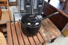 A traditional travel or stove cooking pot in black enamel