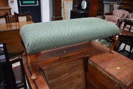 An early 20th Century footstool on Queen Anne style legs with later green upholstery, width approx