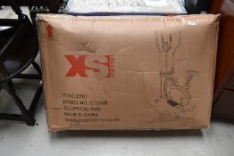 An XS sports elliptical bike, still boxed