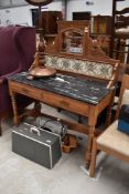 A Victorian stripped washstand with marble top and tile and mirror back