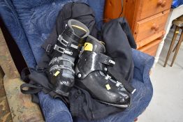 A pair of skiboots and suit