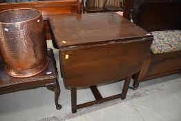 A dark stained Ercol style drawer leaf dining table, approx. width 47cm