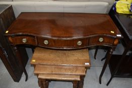 A reproduction mahogany and inlaid serpentine front side table, having triple frieze drawer, width