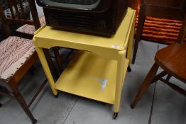 A vintage painted tea trolley of square form, raised on slender casters, approx 51cm wide