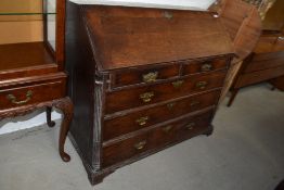 An antique writing bureau and three over two drawer set with compartmental interior and drop front