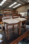 Two modern ladder back dining chairs in medium stained oak