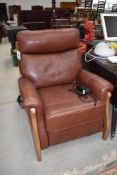 A modern leather and wood frame electric recliner chair