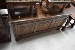 A traditional styled bedding box in stained oak