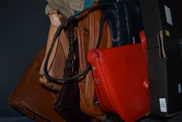 A collection of handbags, a lot leather and some still having tags attached also a vintage tan