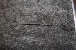 A long handled coal scoop or similar.