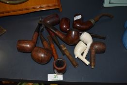 An array of vintage traditional pipes, names such as Carey Magic inch,Bari Ruby etc, some clay bowls